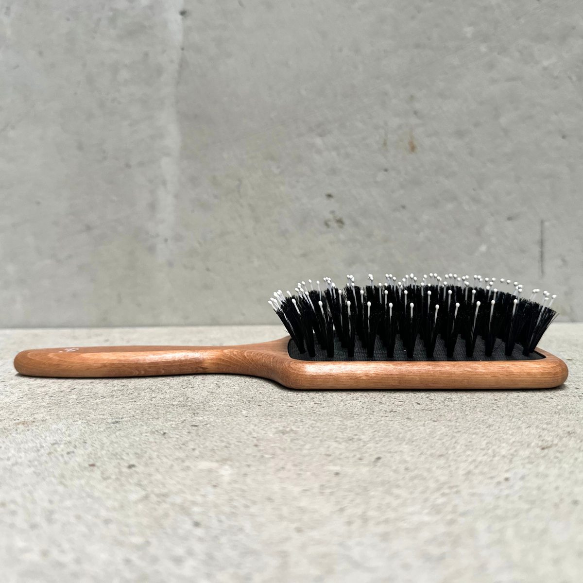 Paddle pin hair brush with natural bristles, rounded nylon pins and beechwood handle for thick hair by Faller Germany.