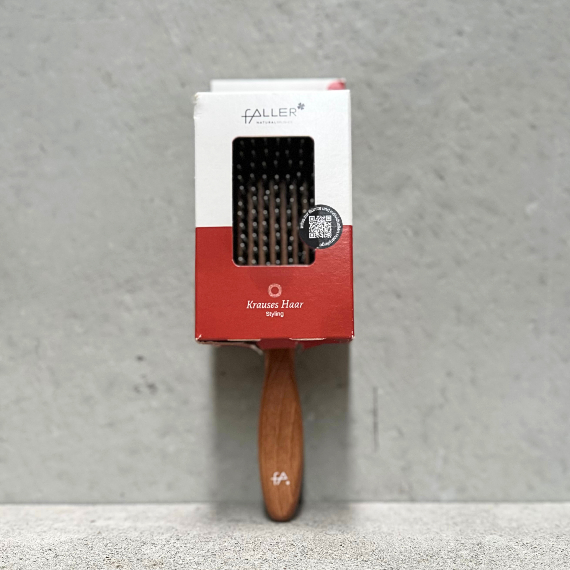 Paddle hair brush with natural bristles, rounded nylon pins and beechwood handle for curly and frizzy hair by Faller Germany.
