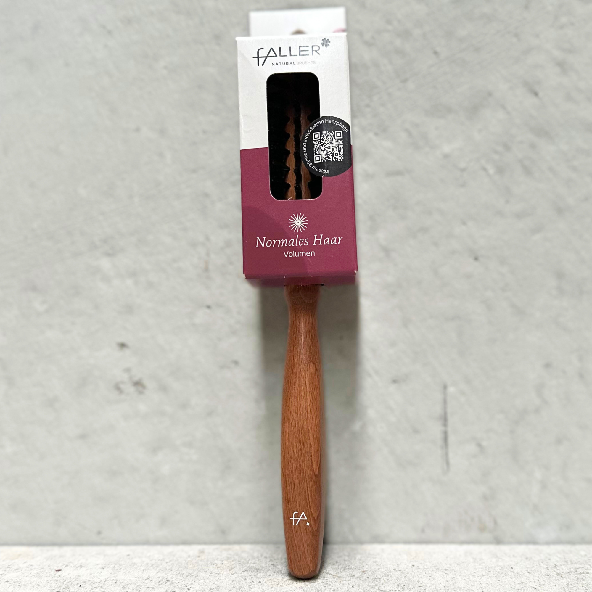 Round hair brush with natural bristles and beechwood handle for normal hair by Faller Germany.