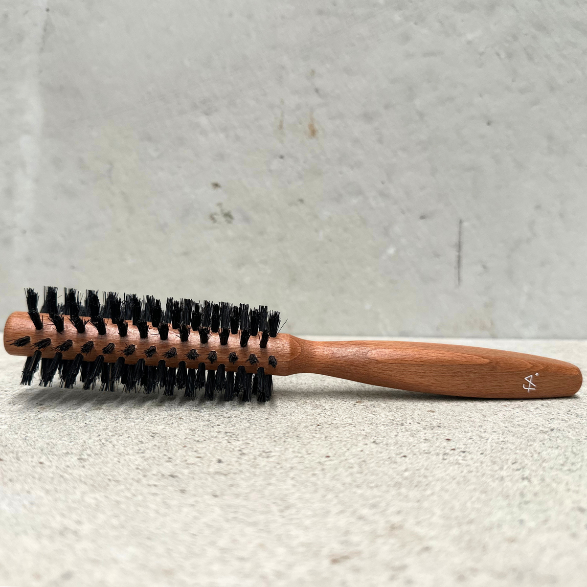Round hair brush with natural bristles and beechwood handle for normal hair by Faller Germany.