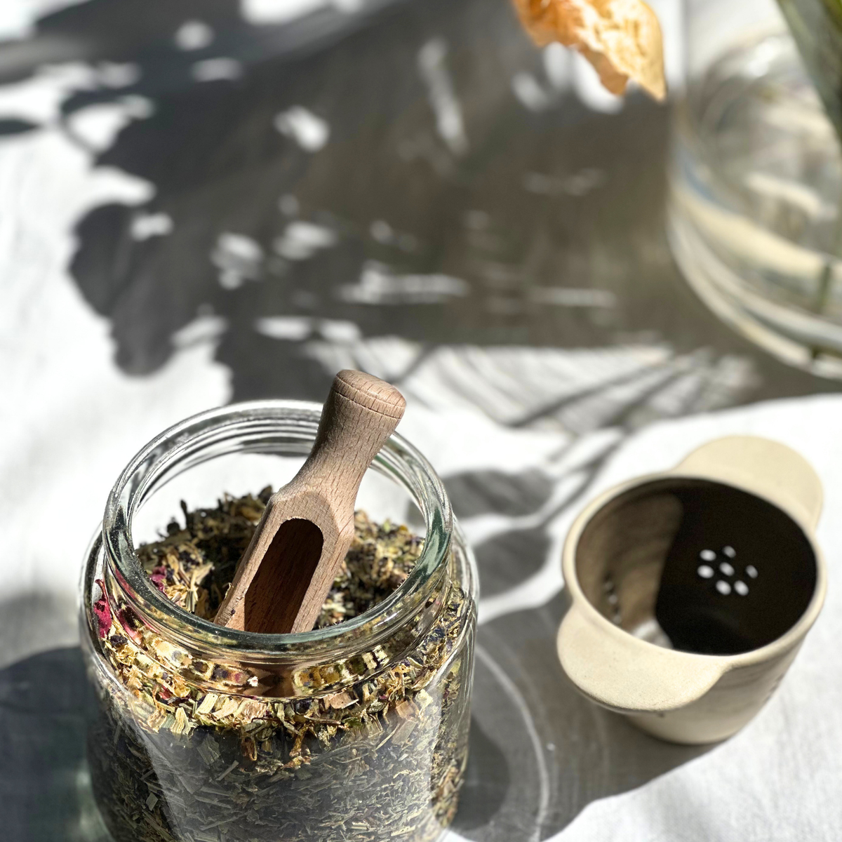 Handmade ceramic tea strainer with side handles for brewing loose leaf tea, made in Sydney, Australia.