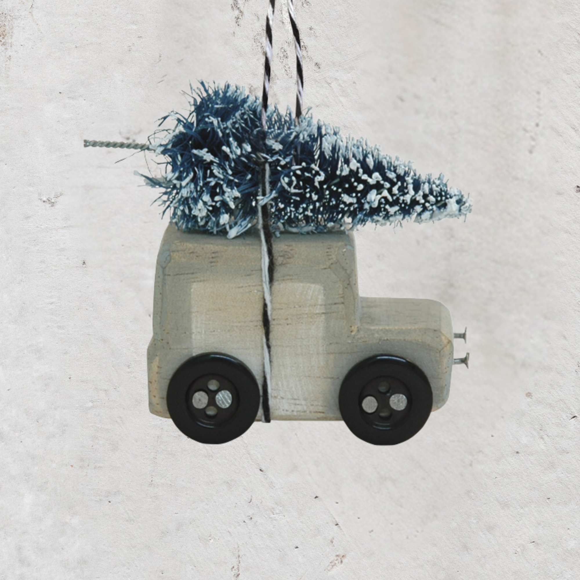 Wooden Christmas van decoration carrying a miniature snow-covered tree by East of India.
